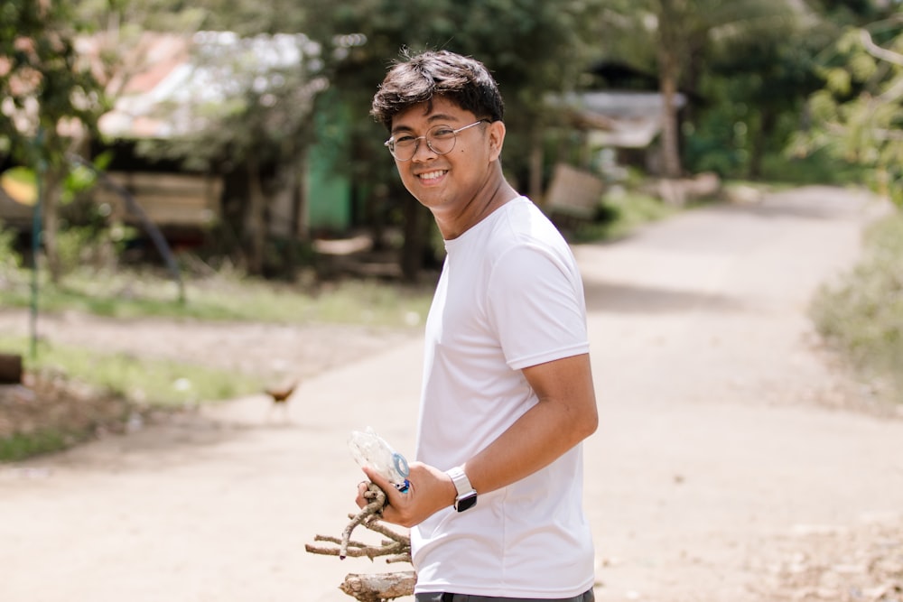 a man holding a bicycle on a dirt road