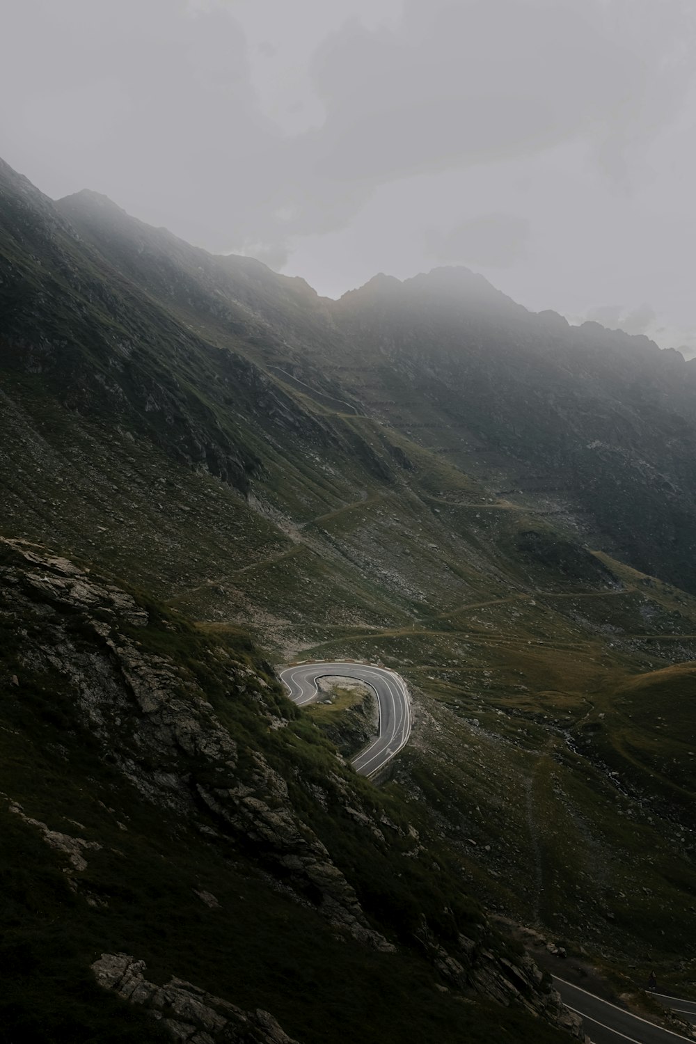 a winding road in the middle of a mountain range