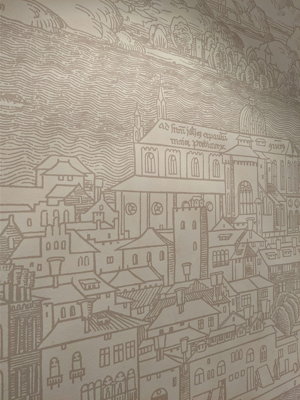 a wall with a drawing of a city on it