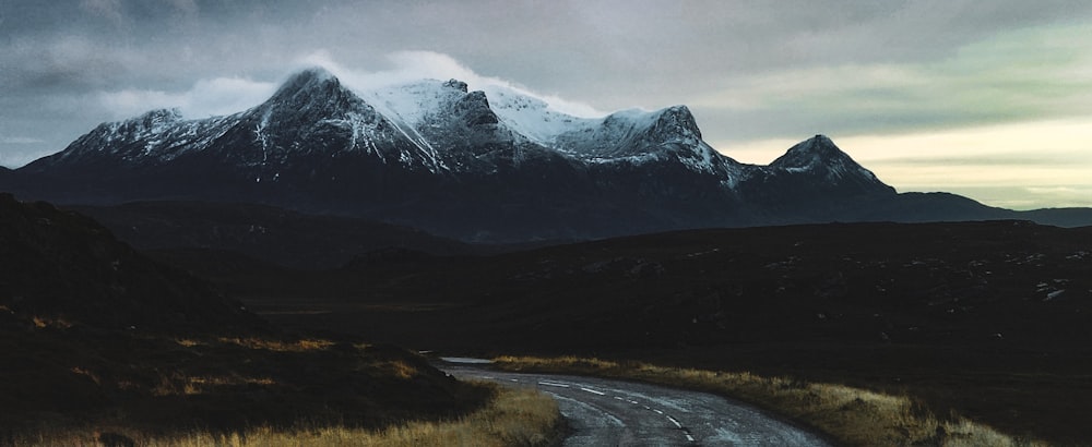 a road with a mountain in the background