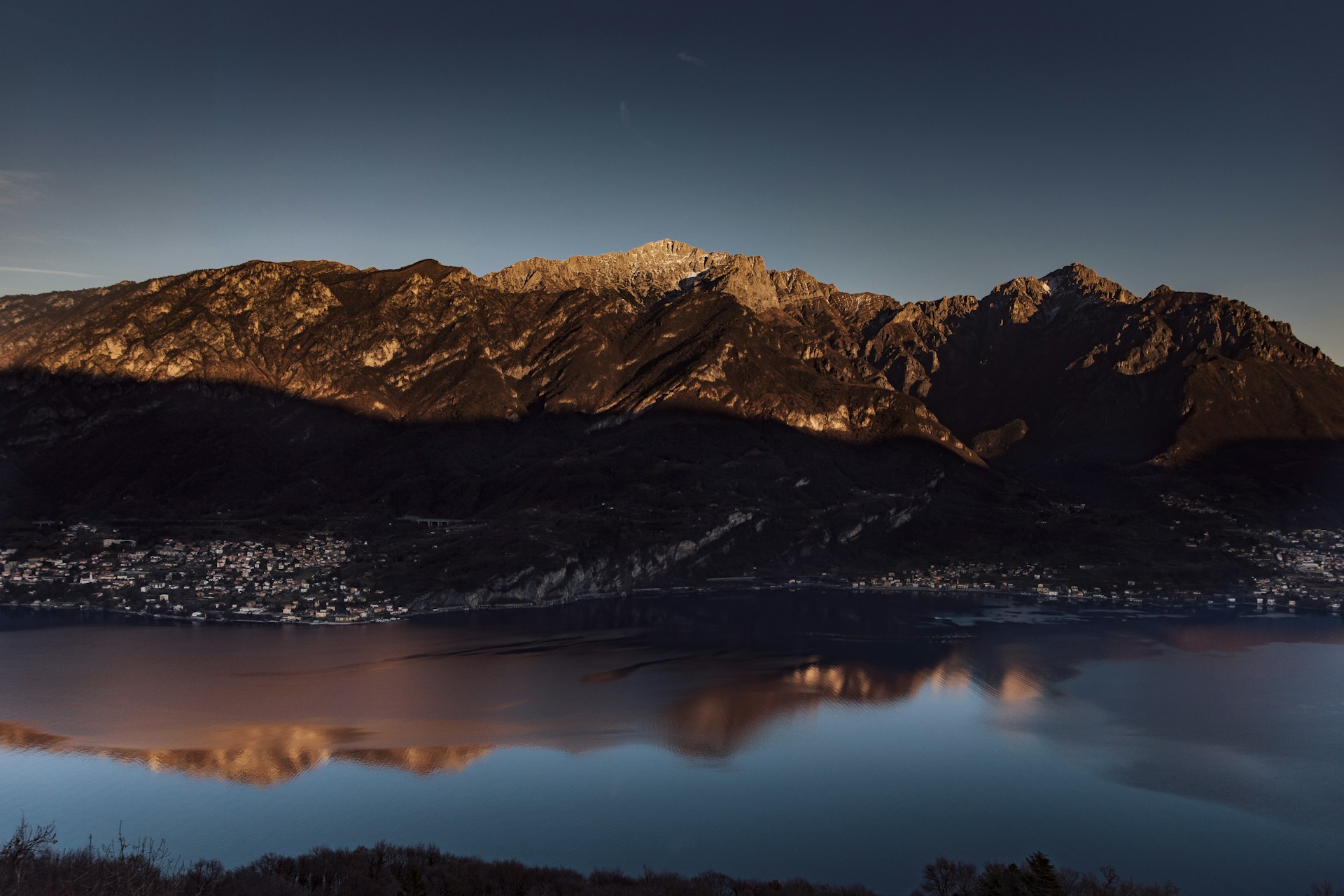 a mountain range with a lake in the foreground