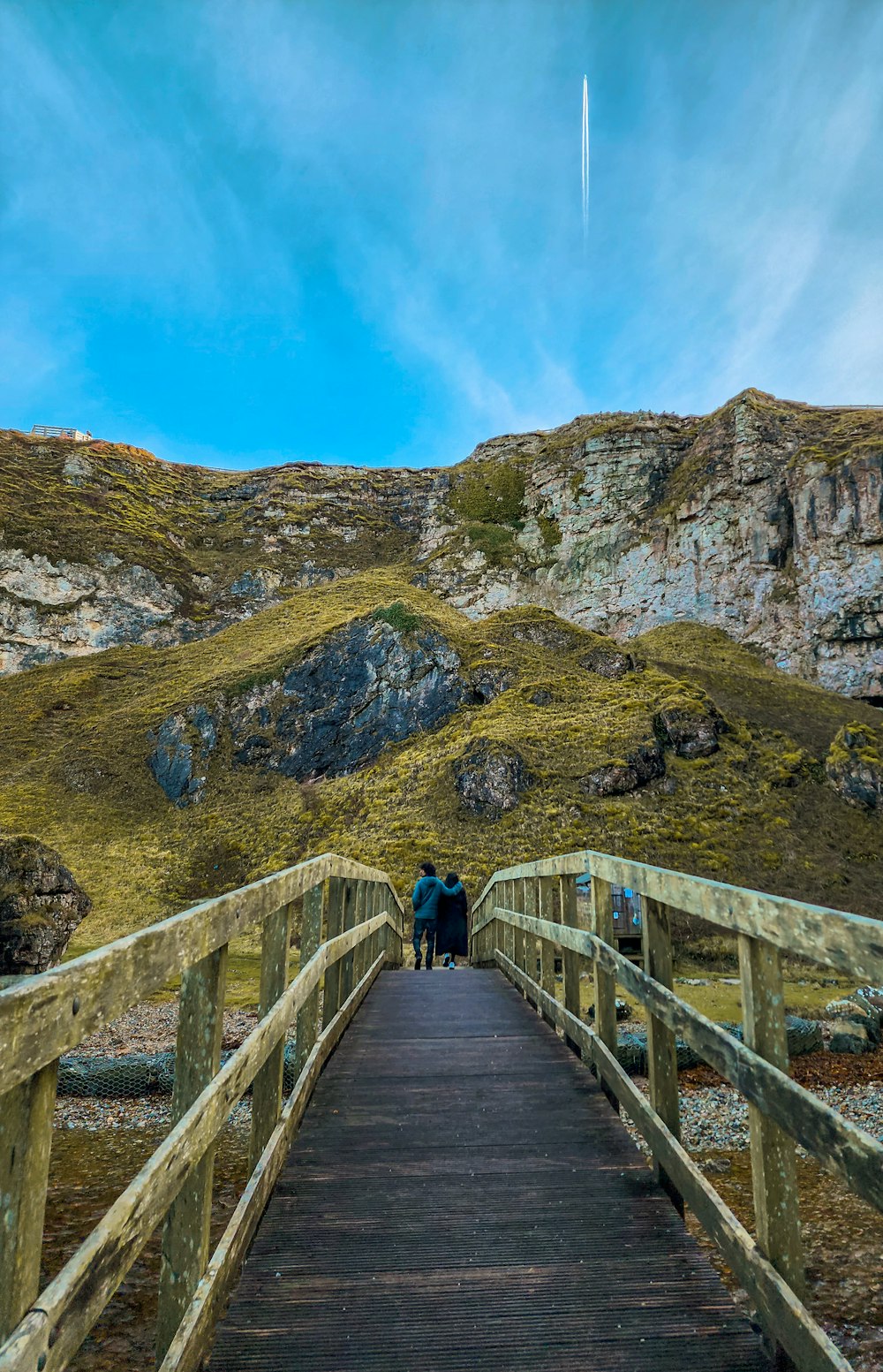 a couple of people that are standing on a bridge