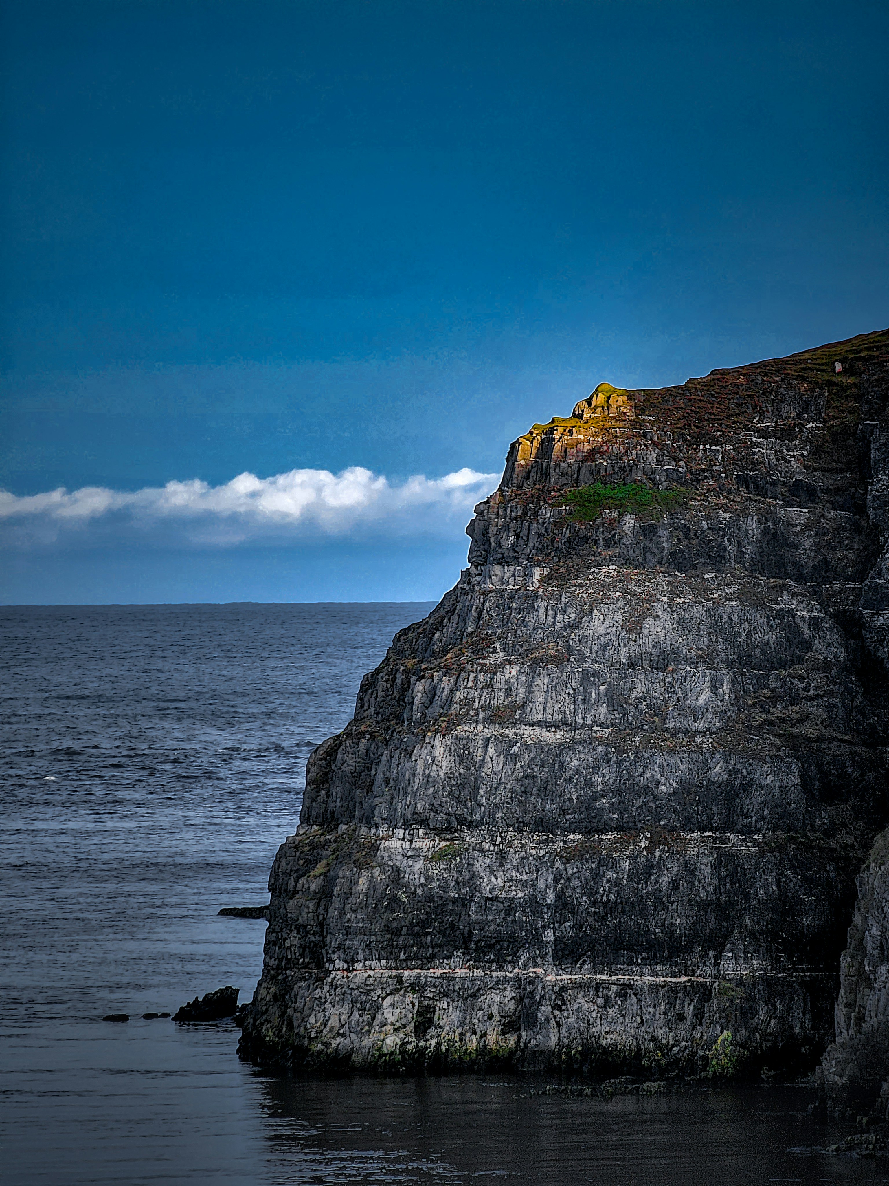 Sun rays hitting the top of a cliff on a warm evening.