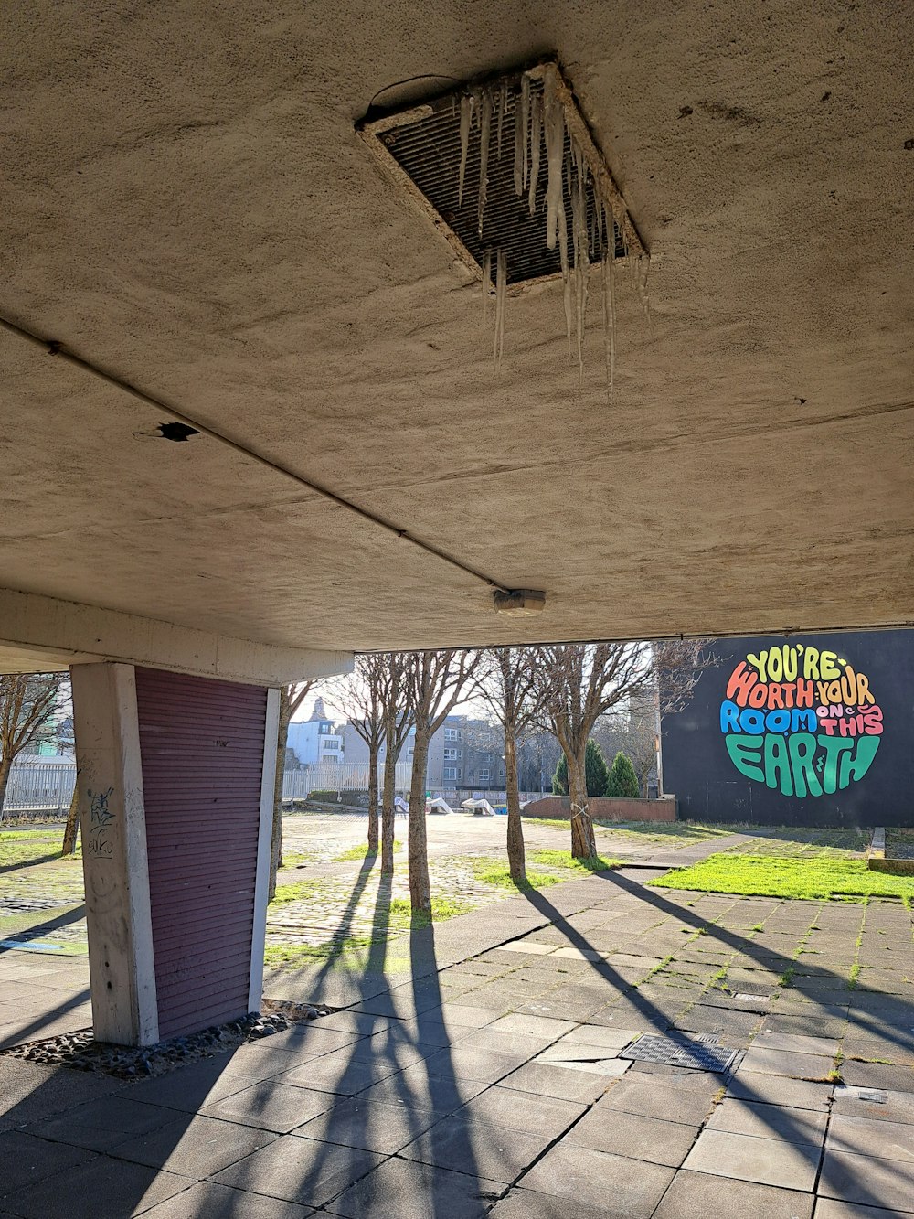 a parking garage with graffiti on the side of it