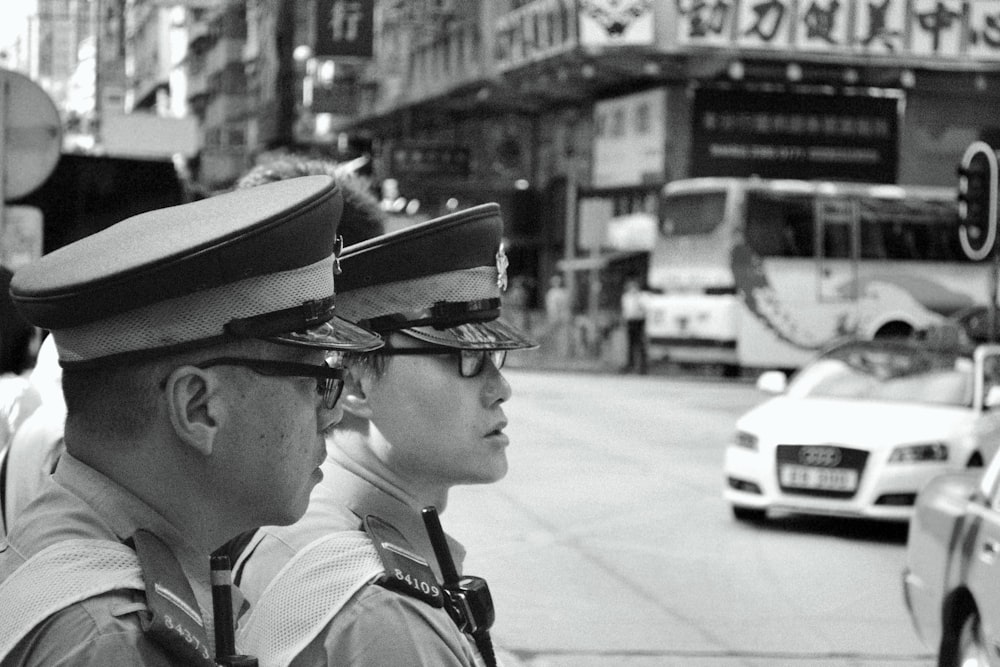 two police officers standing on a city street