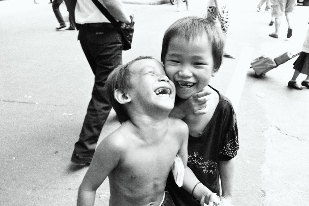 a couple of young boys standing next to each other