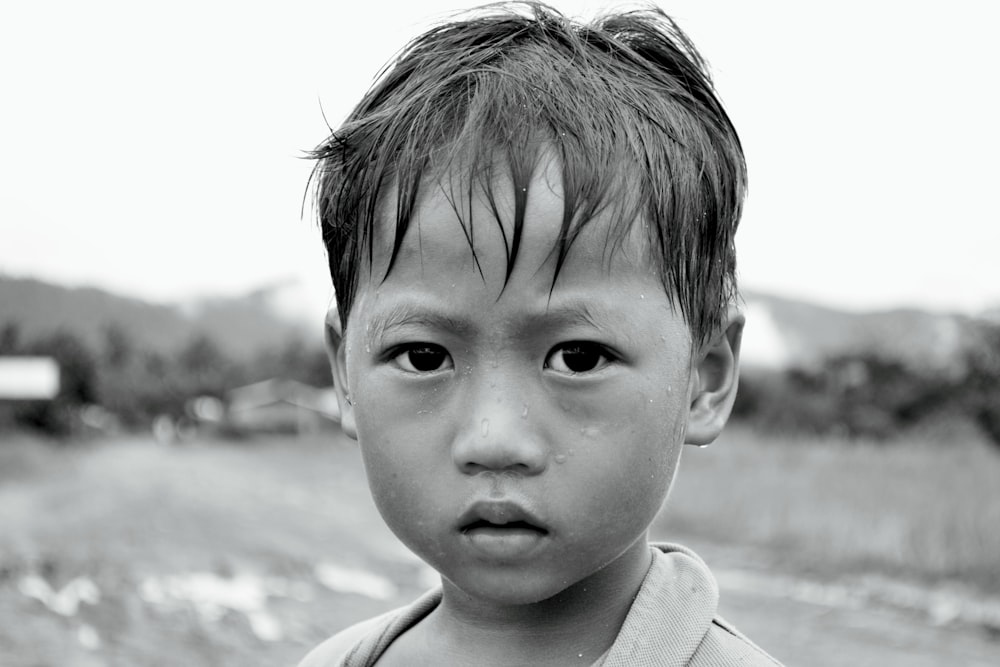a black and white photo of a young boy