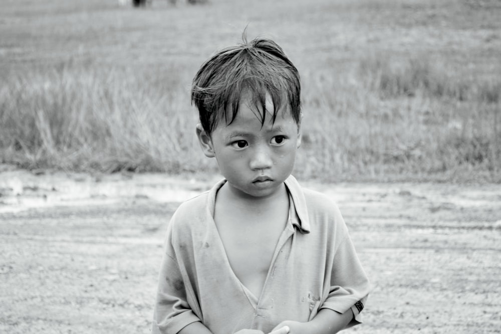 a young boy holding a baseball bat on a field