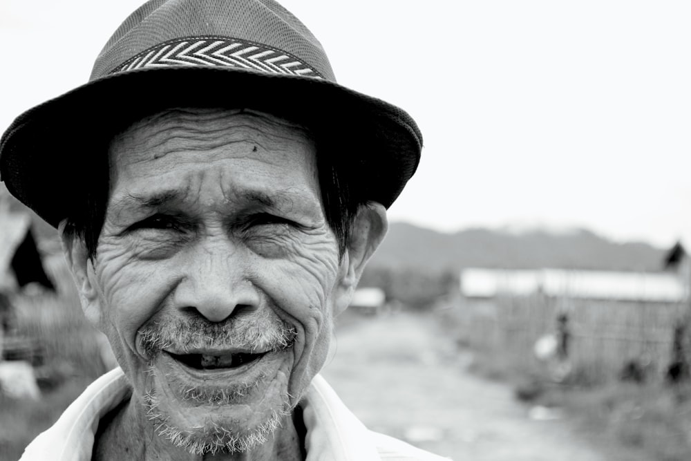 a black and white photo of a man with a hat