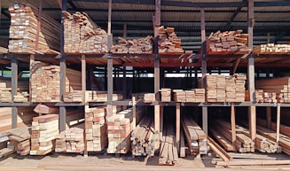 a large pile of wood sitting inside of a building