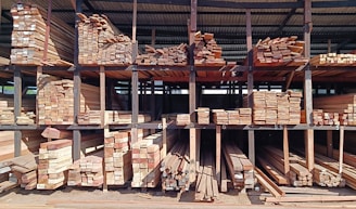 a large pile of wood sitting inside of a building