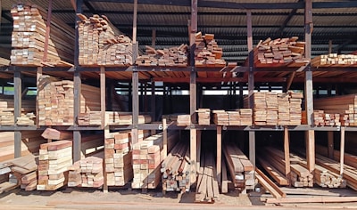 a large pile of wood sitting inside of a building