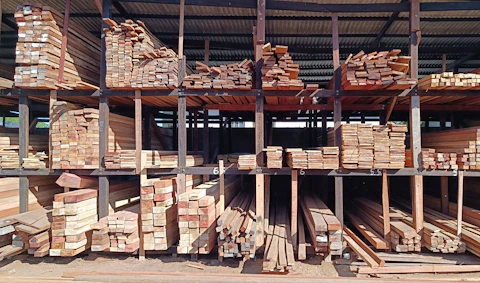 a large pile of timber sitting inside of a building
