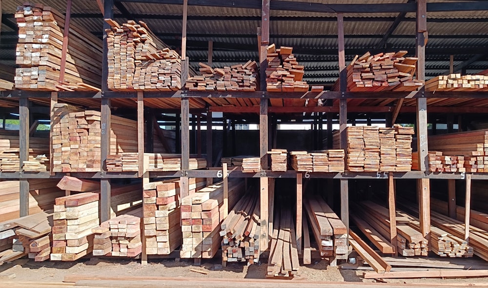 a large pile of wood sitting inside of a building
