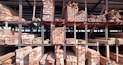 a pile of wood sitting inside of a building