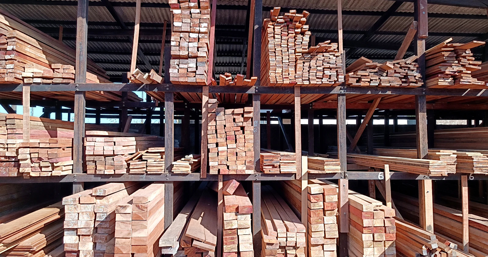 Stack of kiln-dried hardwood lumber inside a workshop