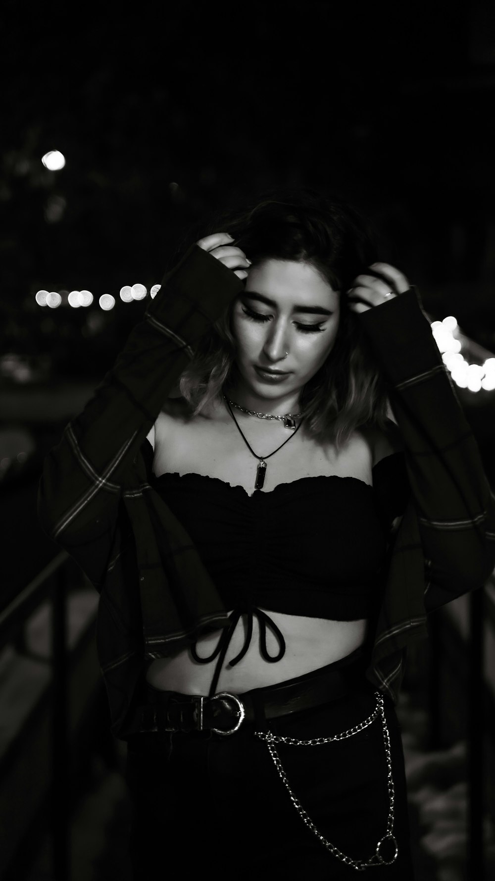 a woman in a crop top and chain belt