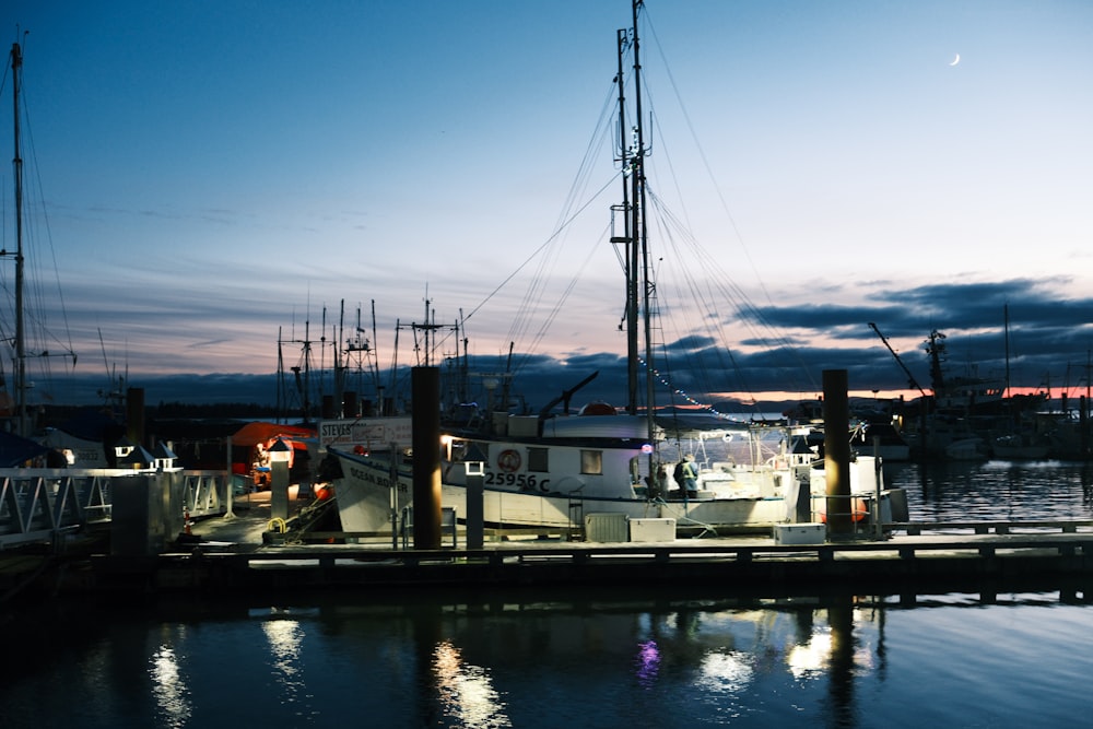 a boat docked at a dock at night