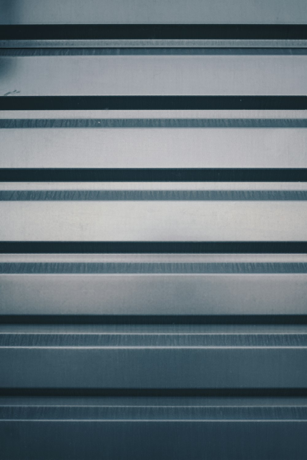 a close up of a metal surface with horizontal lines