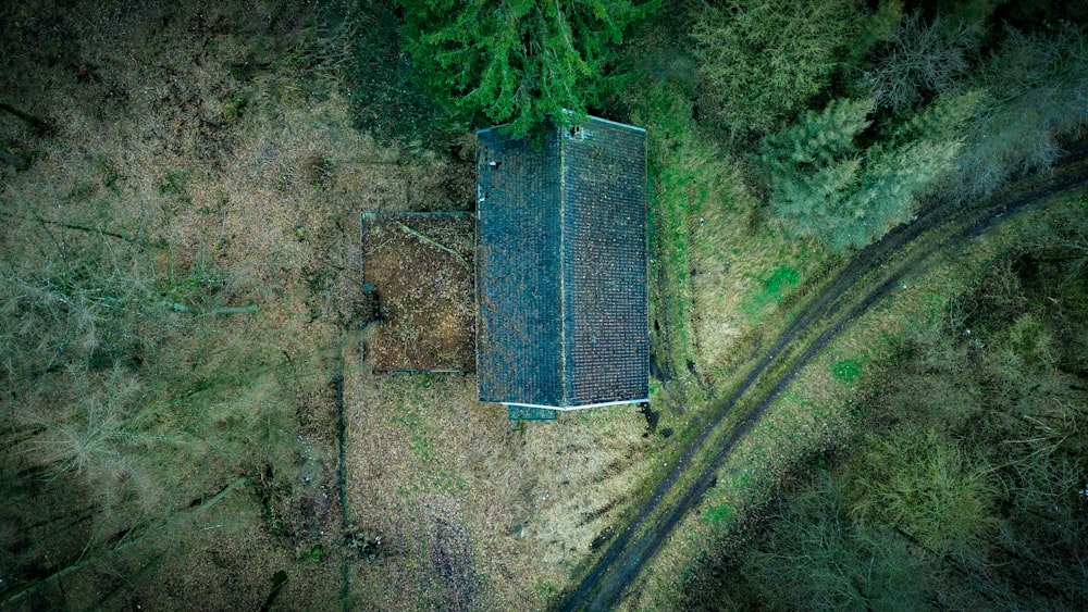 an aerial view of a building in the middle of a forest