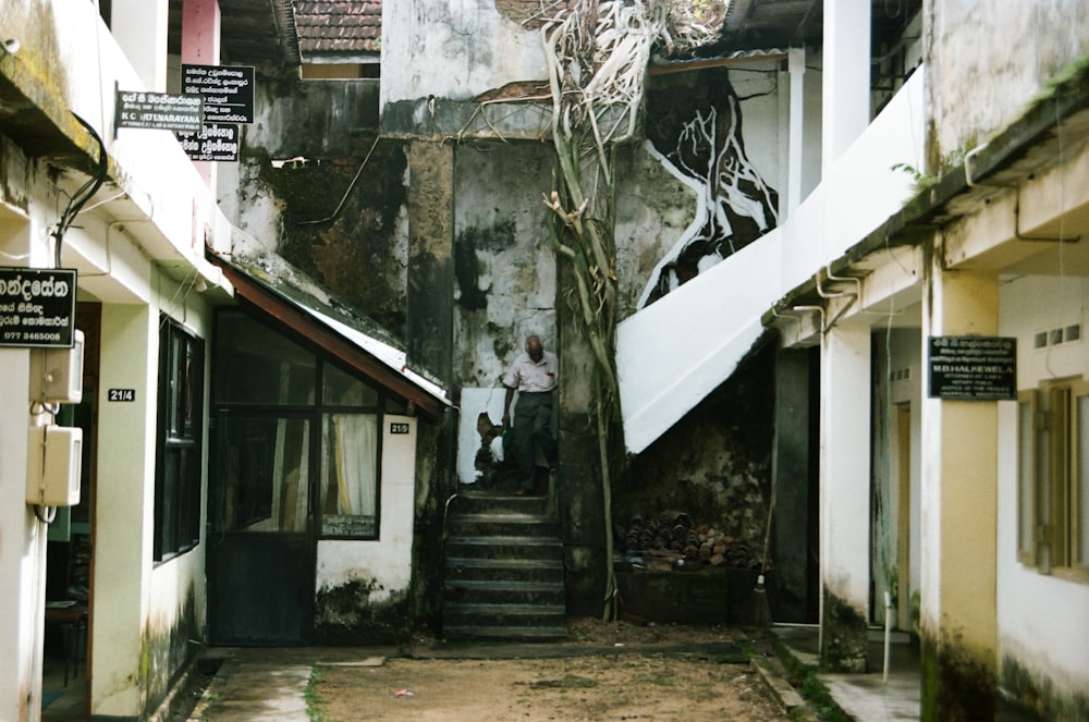 an alleyway with stairs and graffiti on the walls