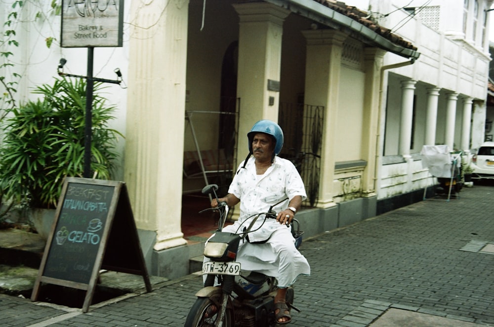 a man riding a motorcycle down a street