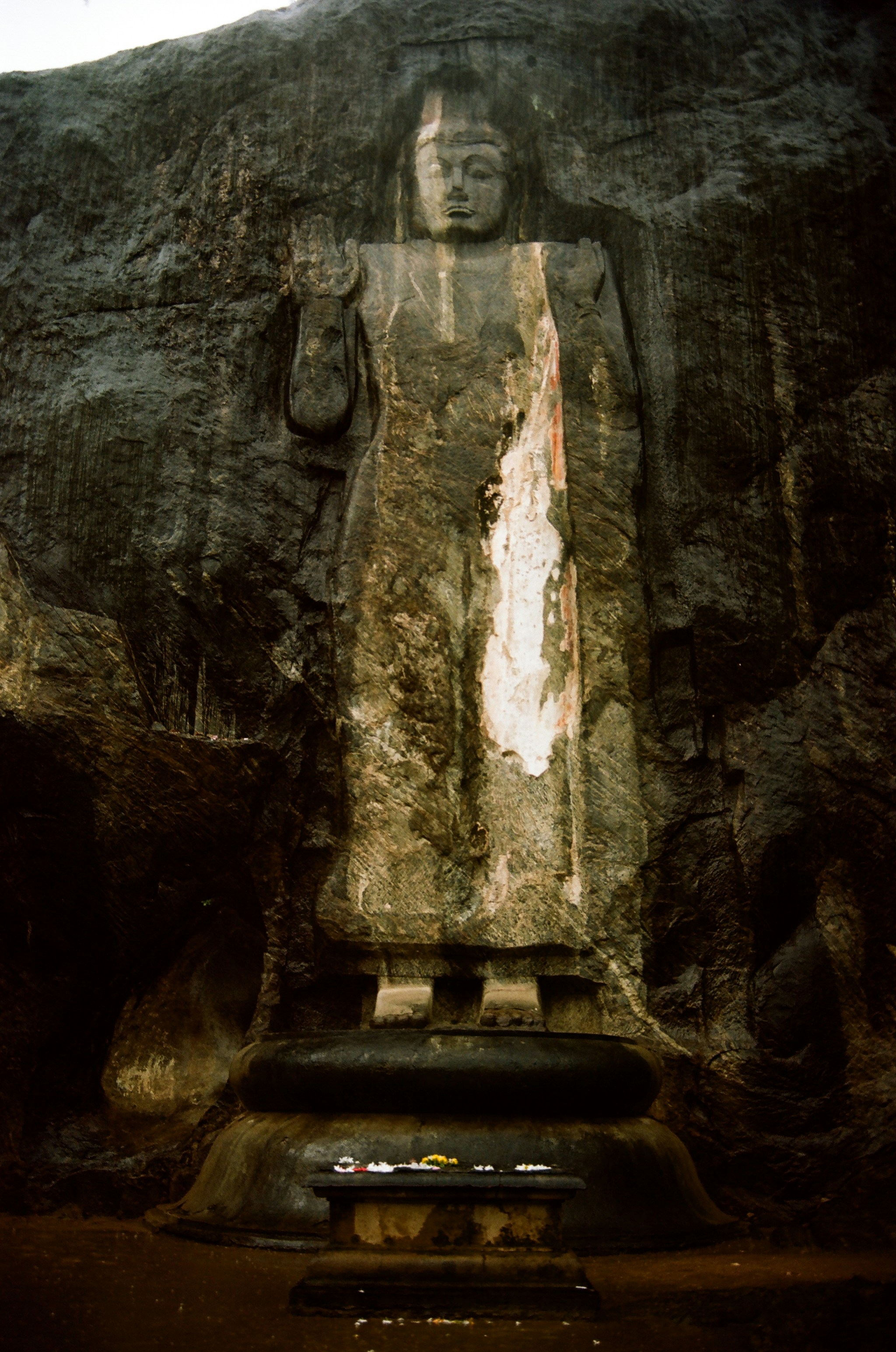 a large statue of a man in a cave