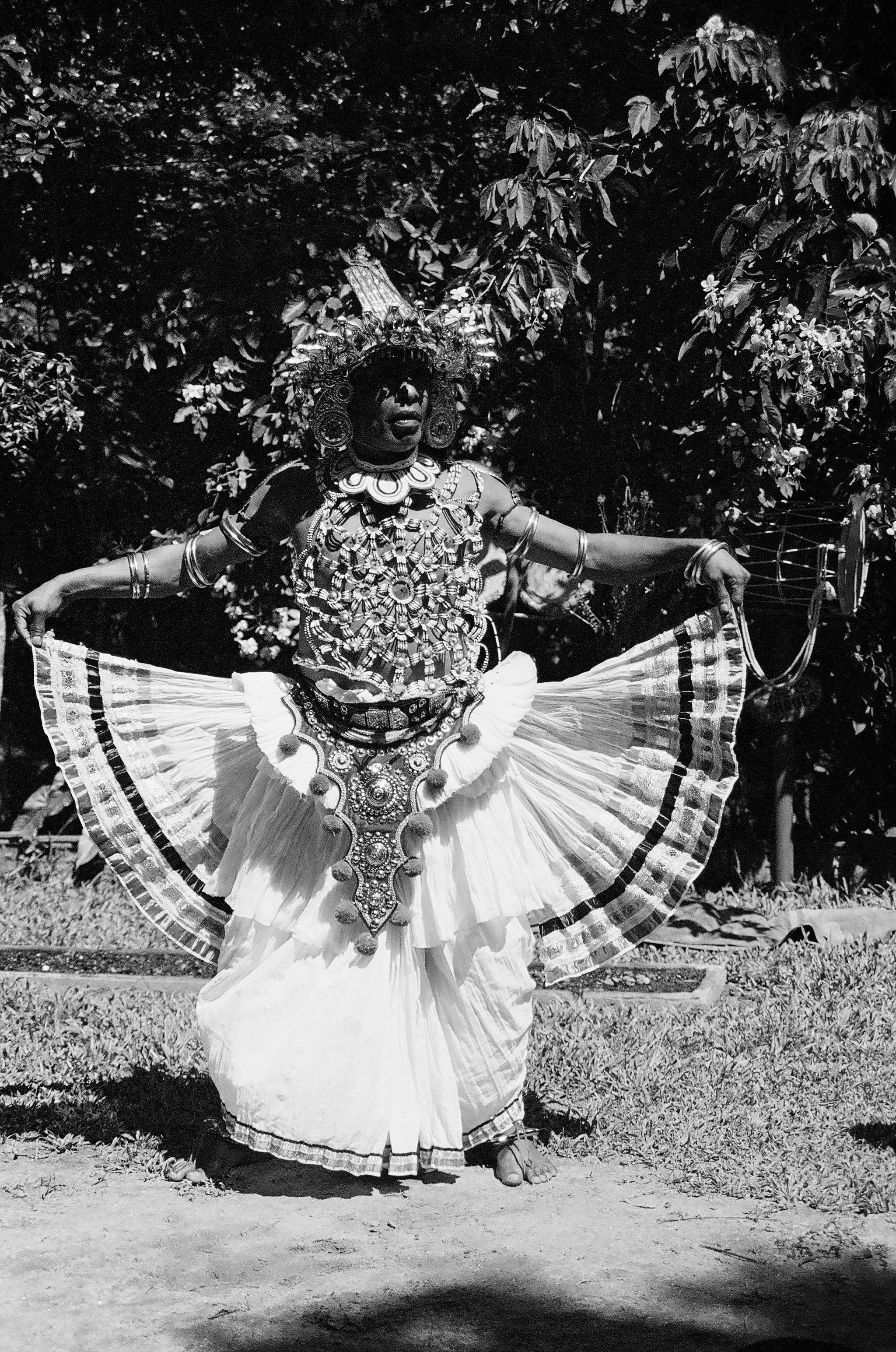 a woman in a dress is dancing in the grass