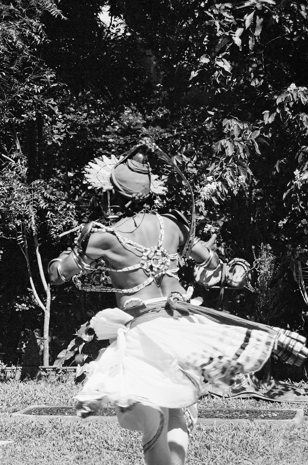 a woman in a costume is dancing in the grass