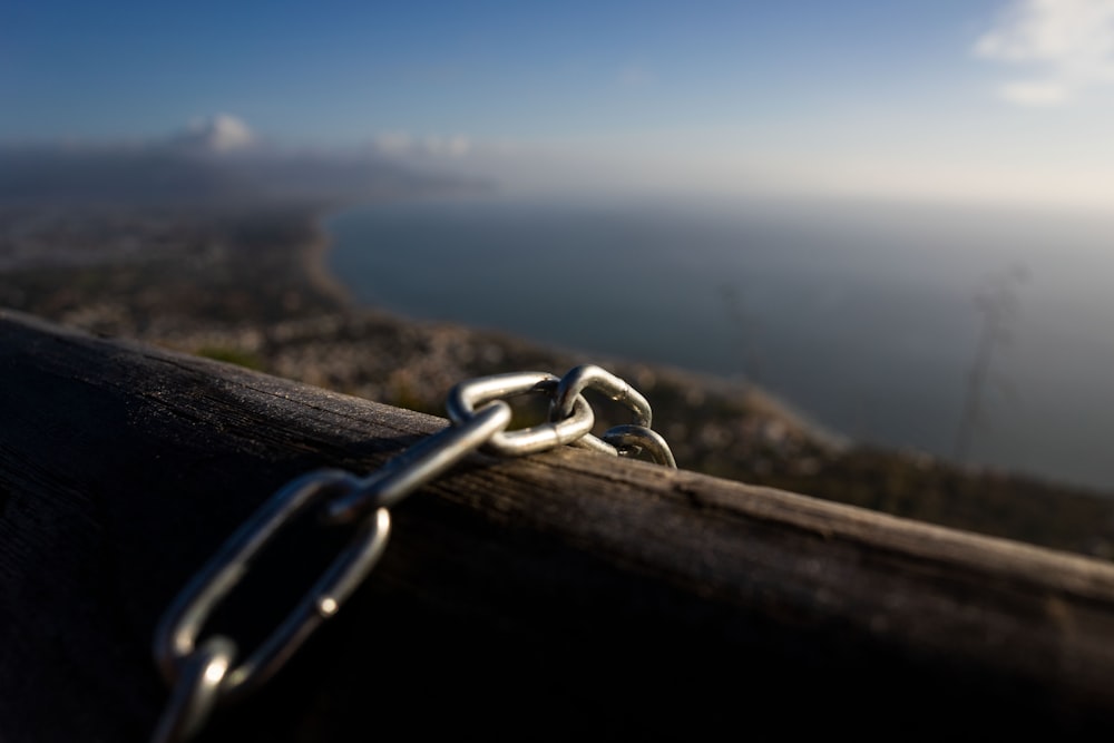 a close up of a chain on a wooden bench