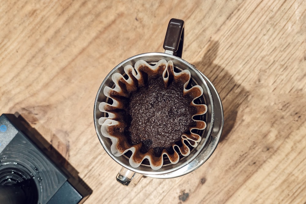 an overhead view of a coffee maker on a wooden table