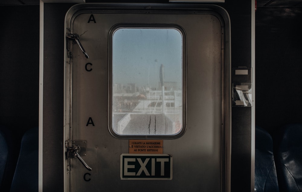 a train door with an exit sign on it