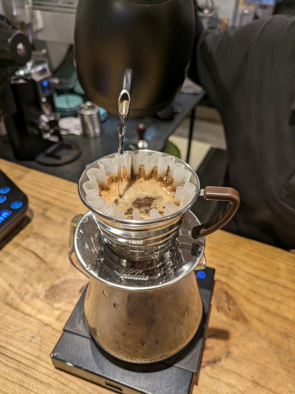 a stove top with a coffee pot on top of it