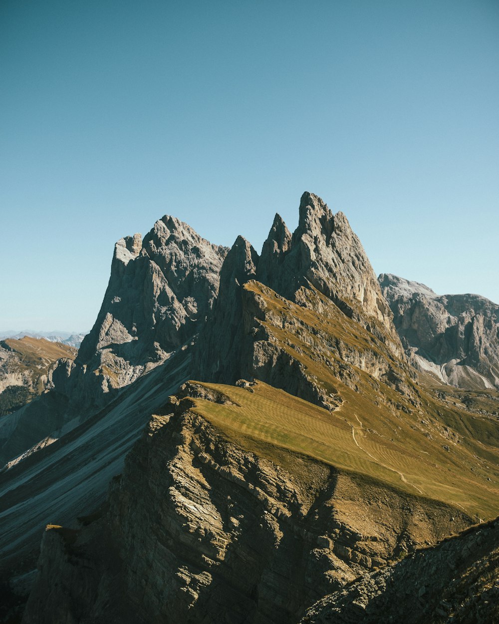 a view of a mountain range from the top of a hill