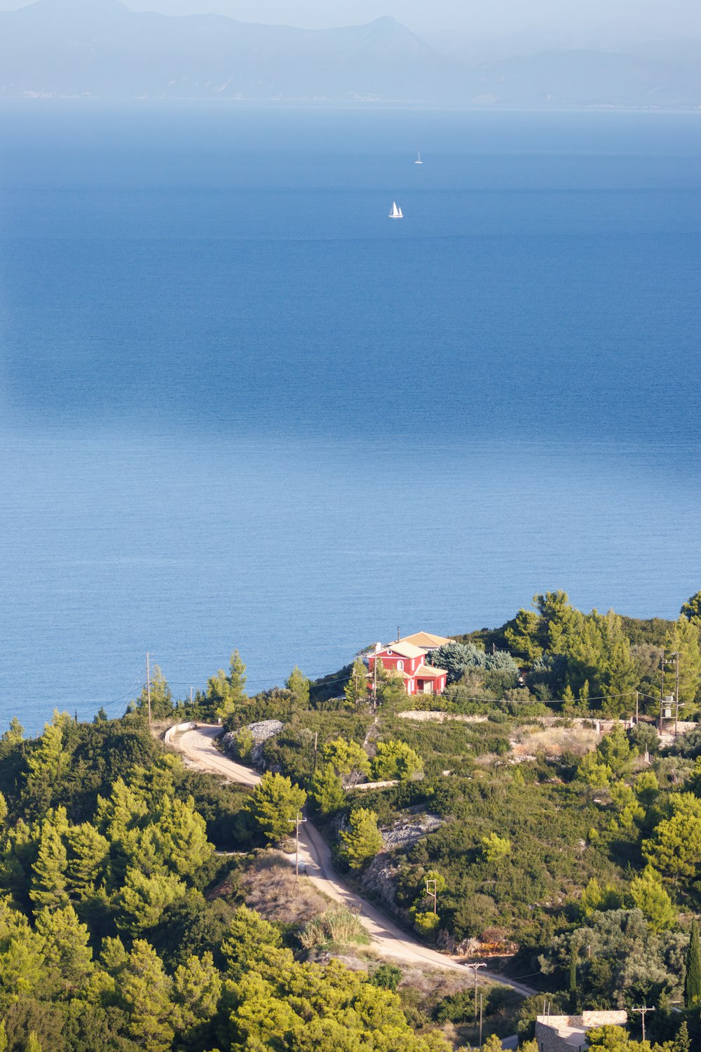 a house on a hill overlooking a body of water