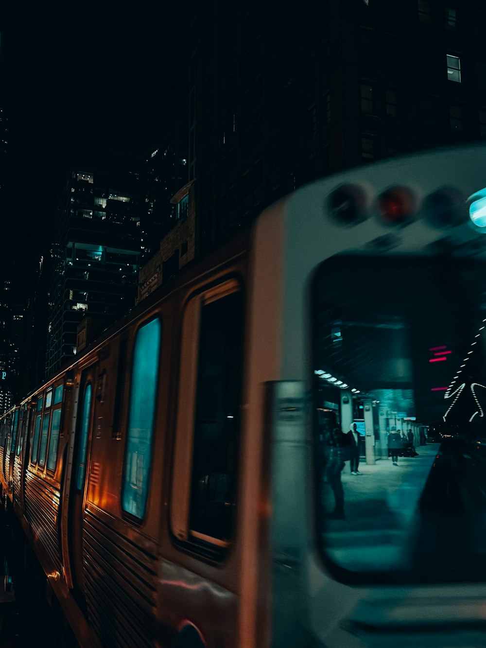 a train traveling down train tracks next to tall buildings