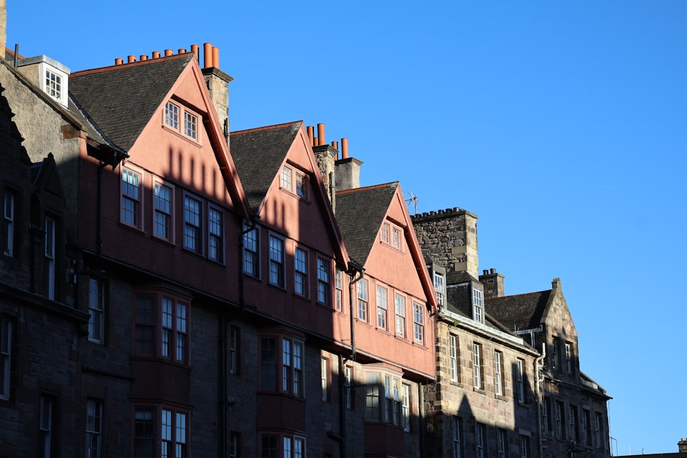 a row of brick buildings with a blue sky in the background