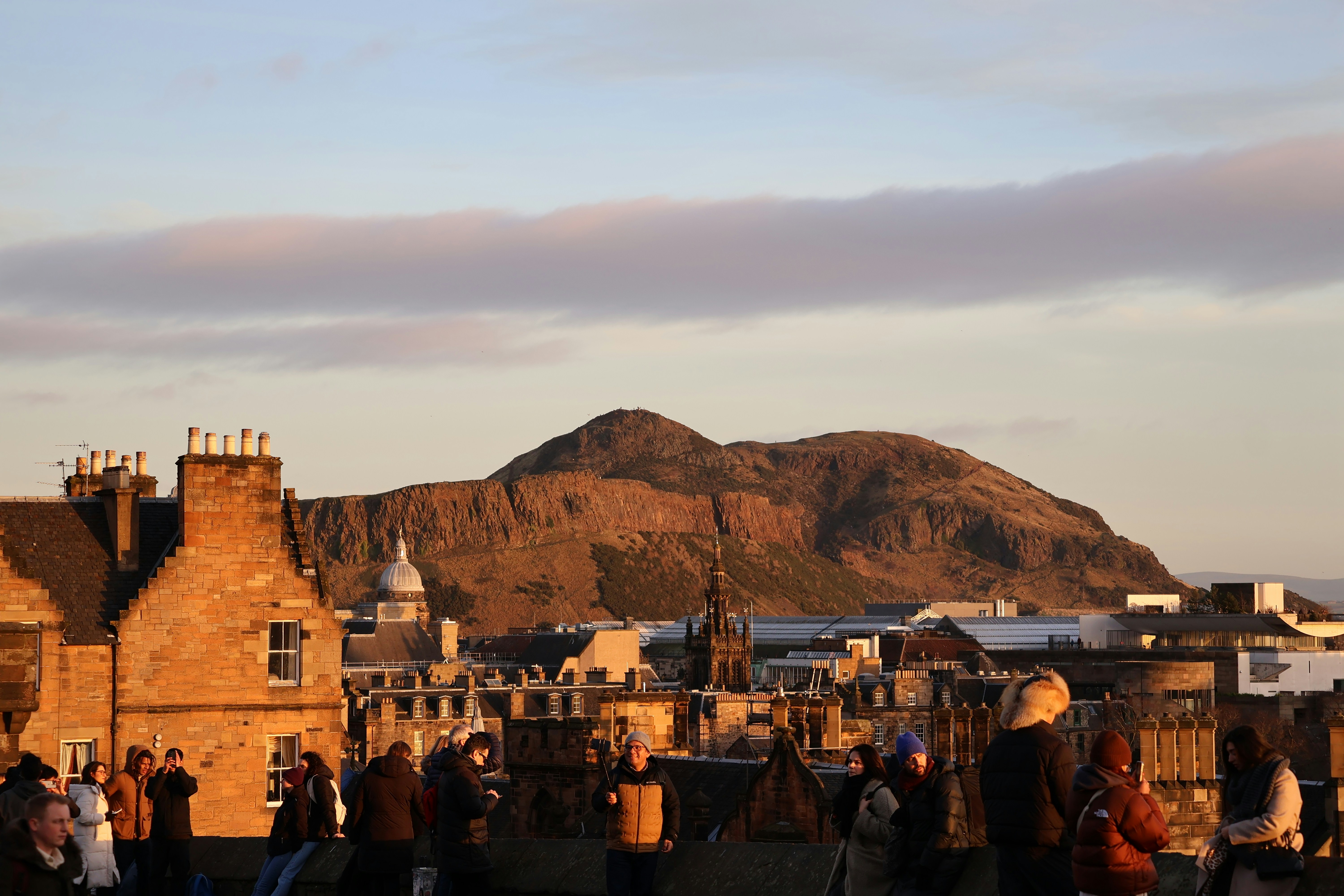 a group of people standing on top of a roof