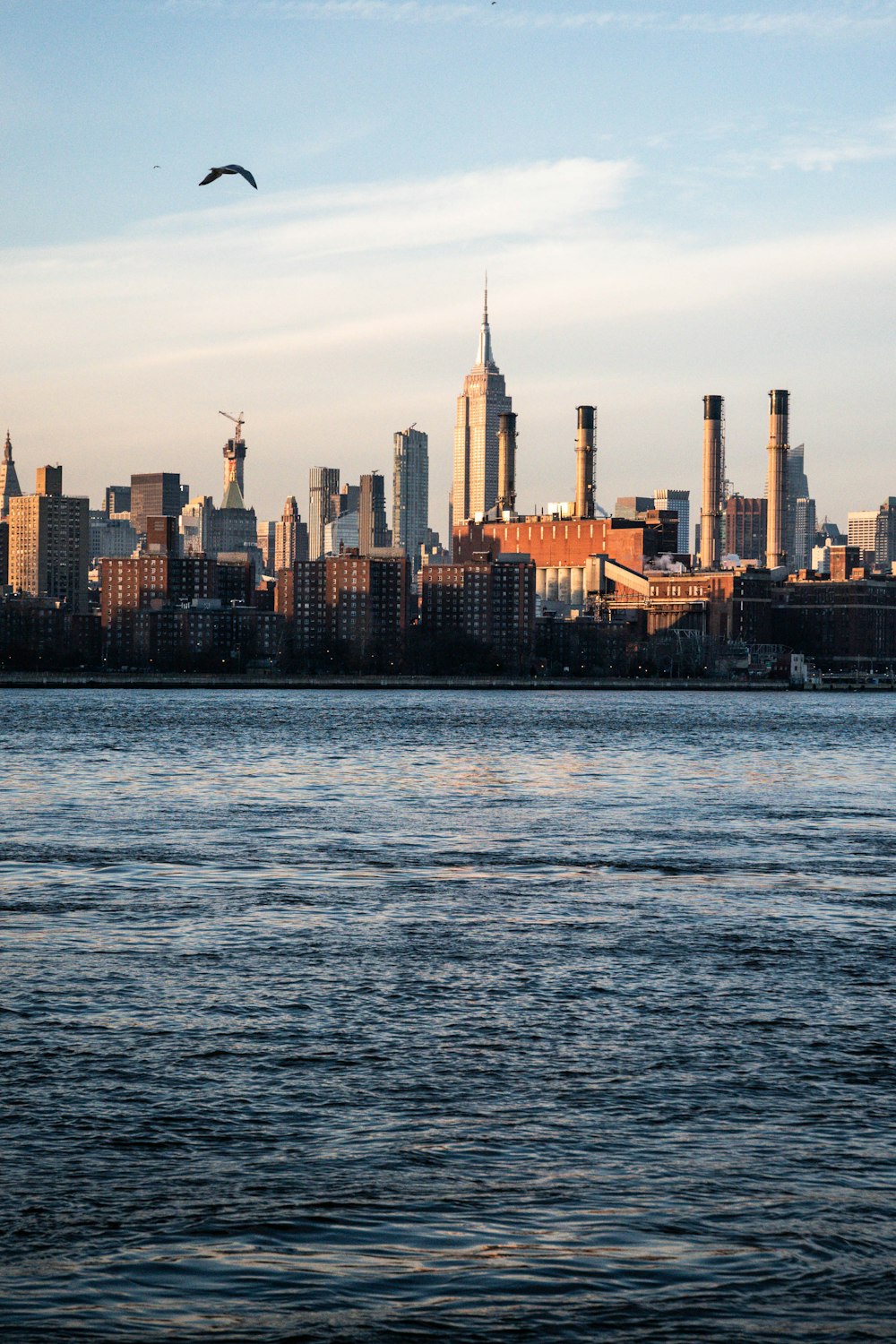 a large body of water with a city in the background