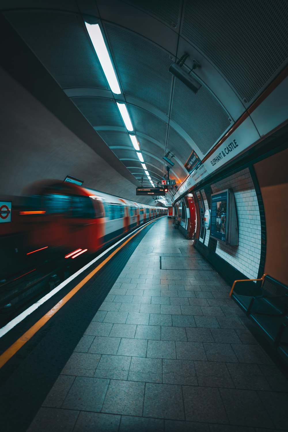 a train traveling through a train station next to a platform