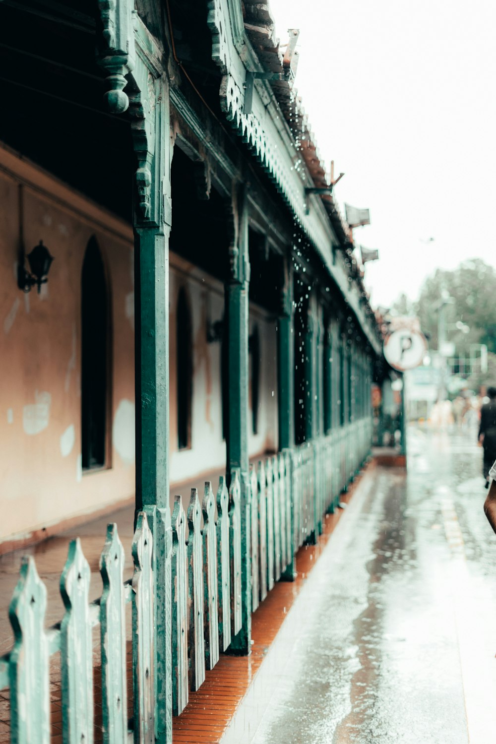 a woman walking down a street in the rain