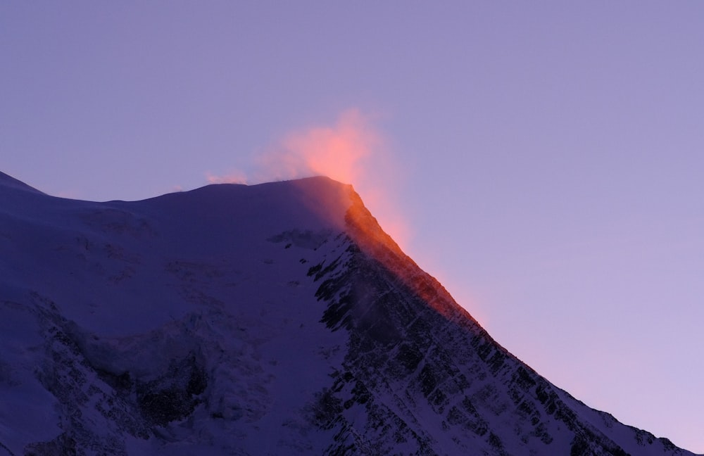 a mountain with a cloud of smoke coming out of it