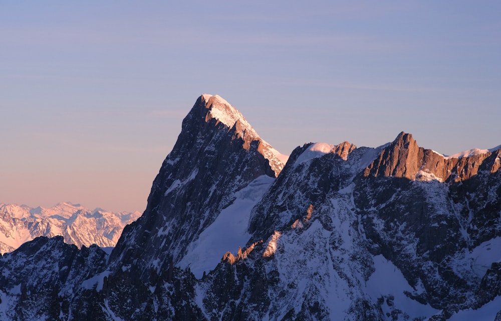 a mountain range with snow covered mountains in the background