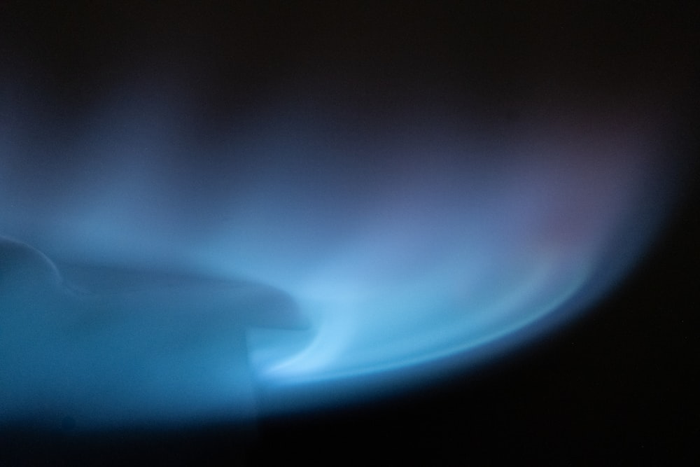 a blurry image of a blue flame on a black background