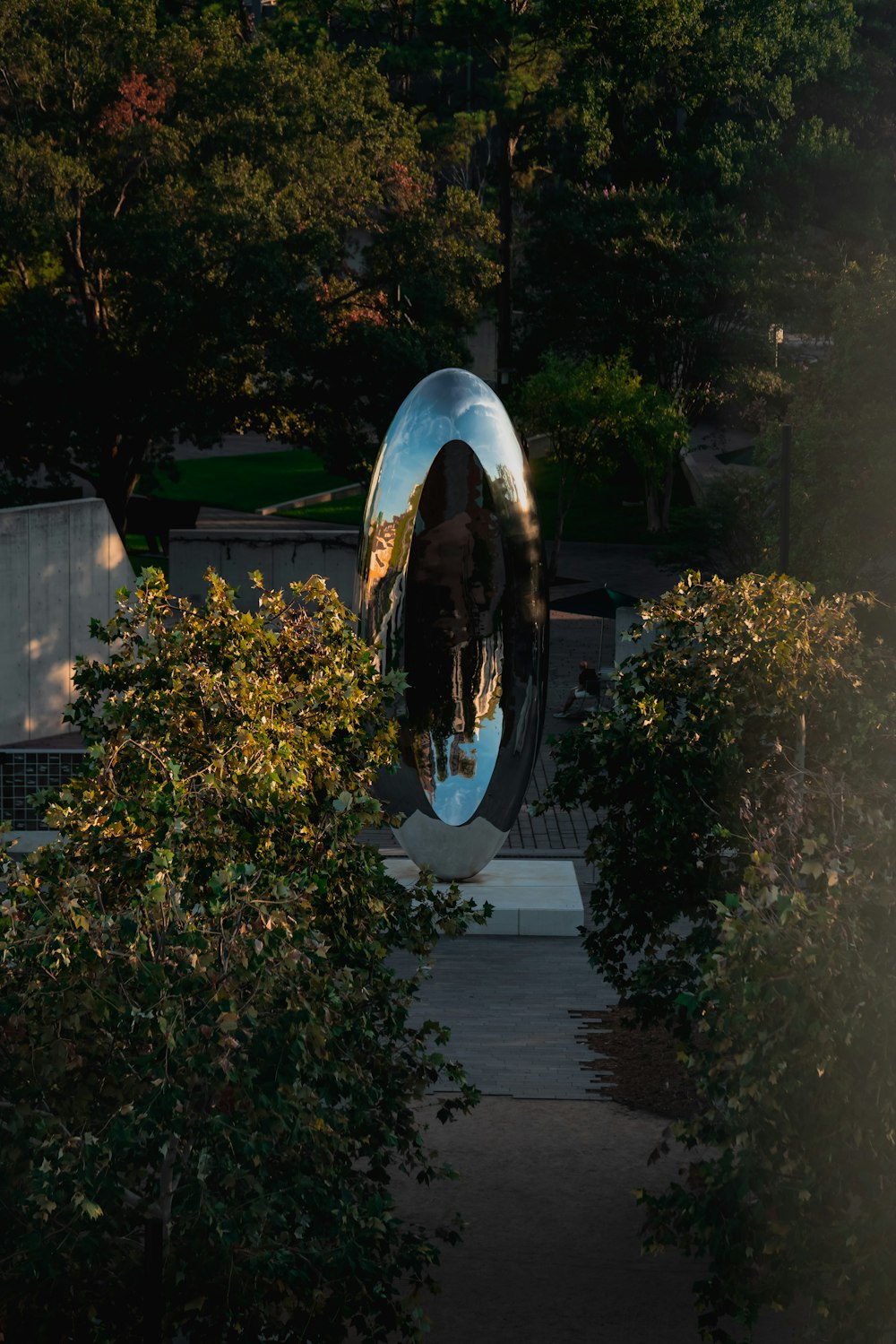 a large circular sculpture in the middle of a park