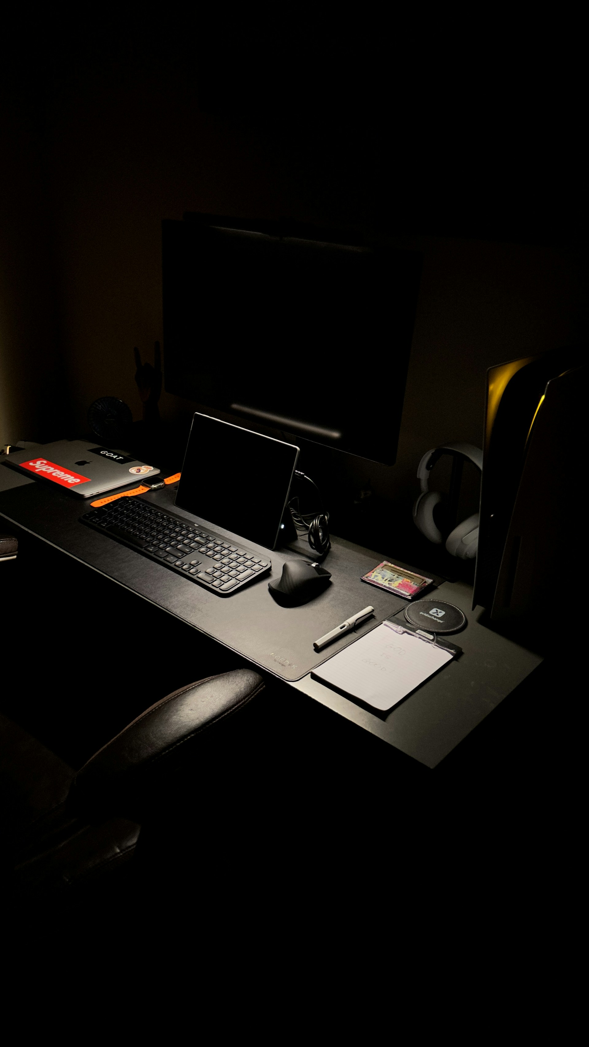 a desk with a laptop, keyboard, mouse and a monitor
