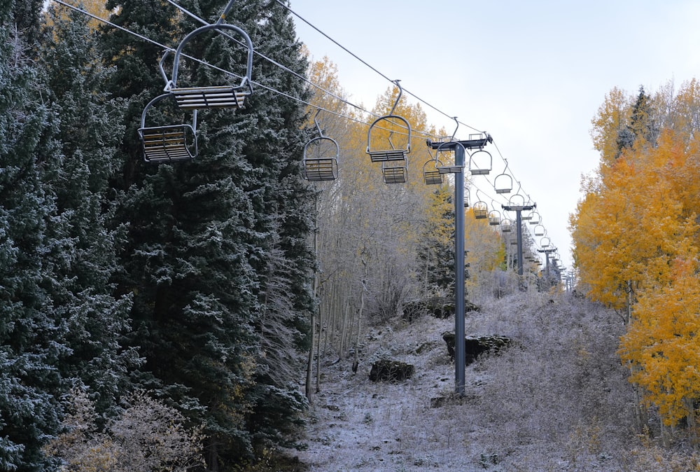 a ski lift going up a snowy mountain