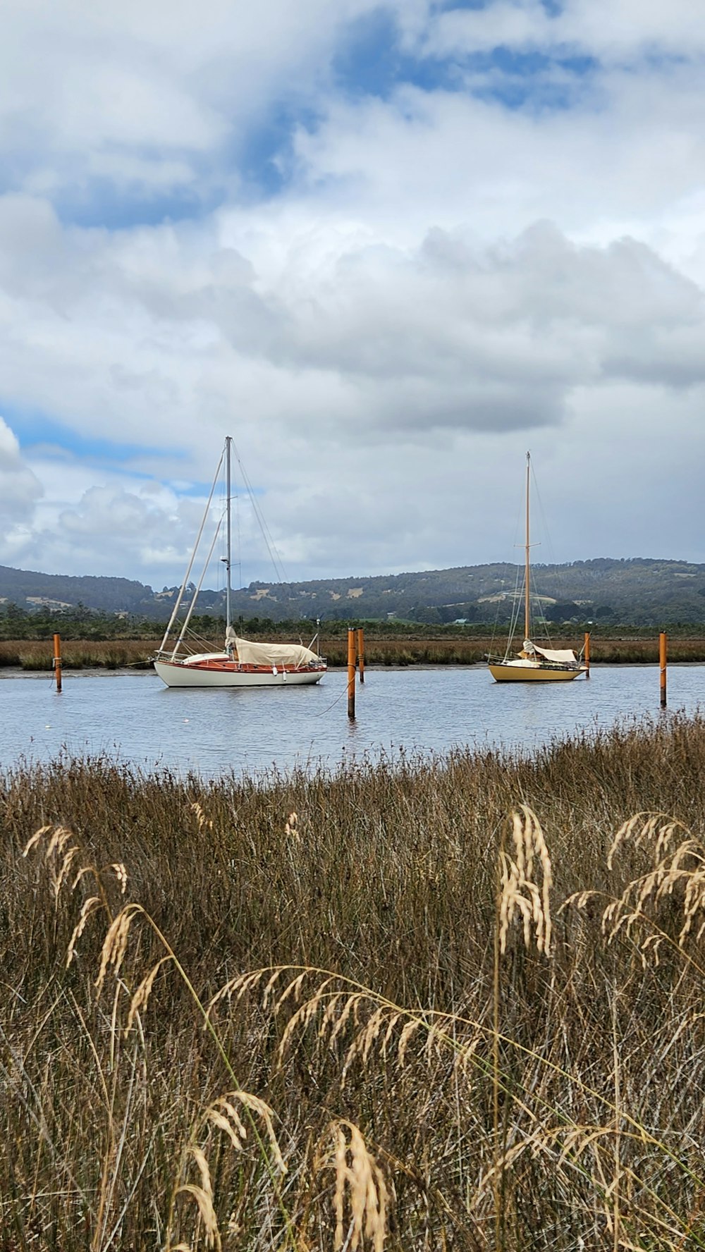 a couple of boats floating on top of a lake