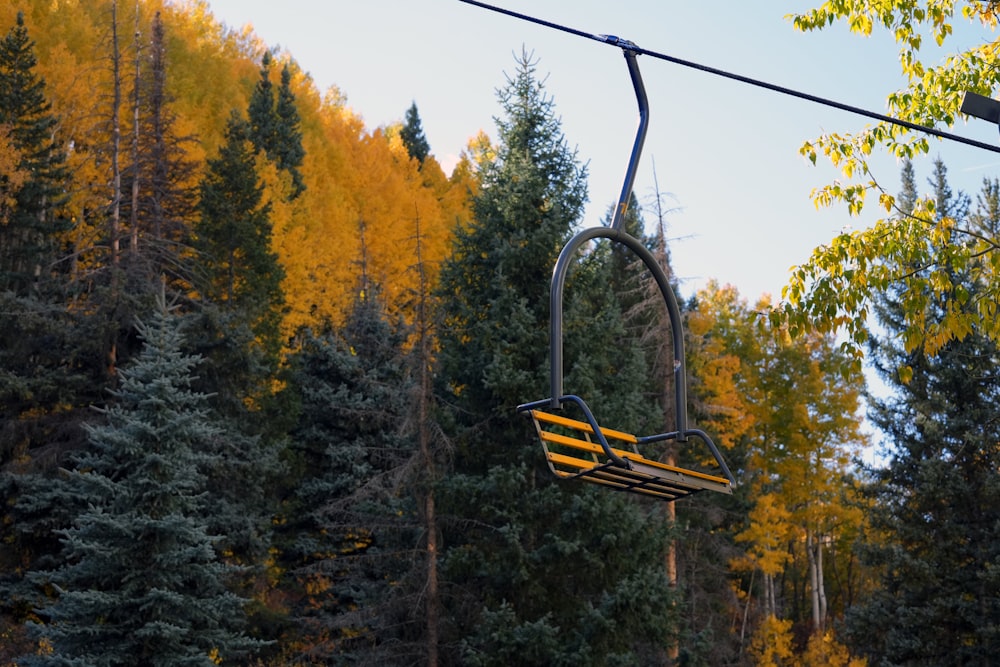 a ski lift in the middle of a forest