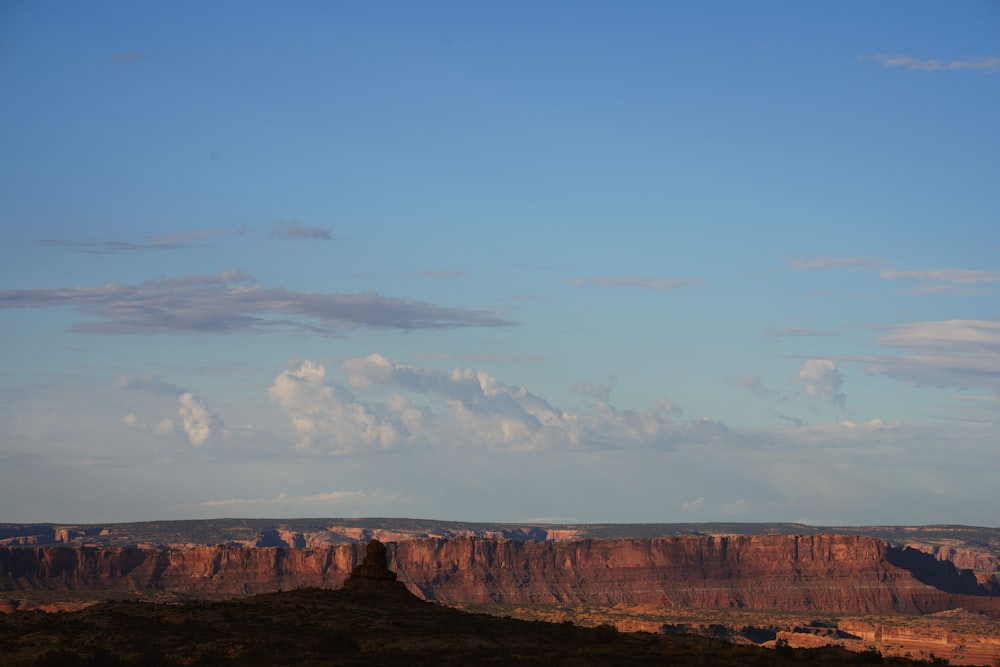 a view of a mountain range with clouds in the sky